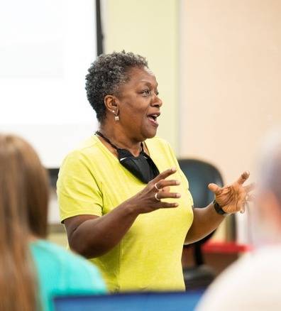 Faye Richardson-Green talking to a room of students